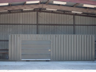 Marine Green Business Modification with Roll Up Door